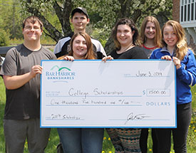 Group of students holding a check