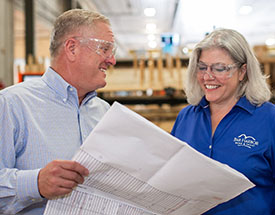 Image of business owner showing blue prints to banker